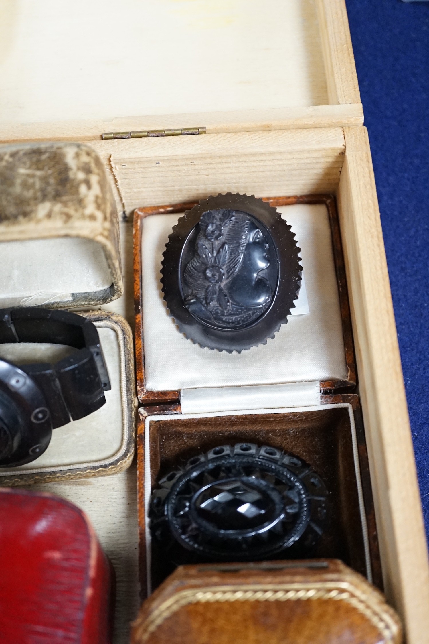 A group of assorted Whitby jet jewellery including three brooches, largest approximately 47mm, three bracelets and a group of French jet? loose pieces.